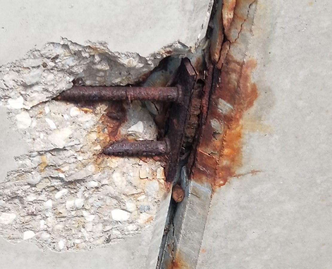 Corrosion at an overhead edge spall.
